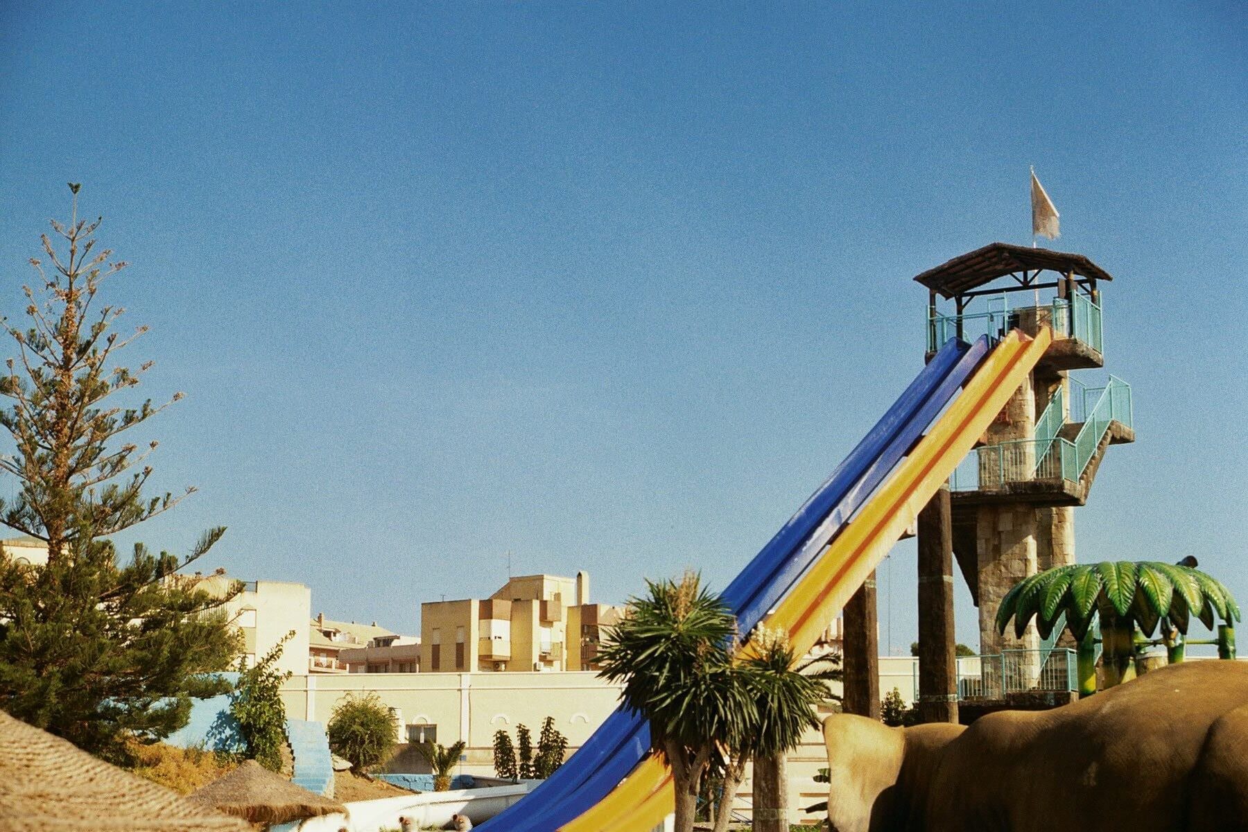 Photo of straight, orange and blue waterslides in southern Europe during summer